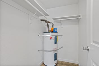 A white wall with a water heater and a pipe. at Cedar Crest, Beaverton, 97078